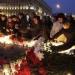 Russians light candles at a rally in memory of the