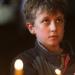 A boy crosses himself during a religious service f
